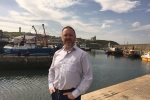 David Duguid standing in fornt of harbour 